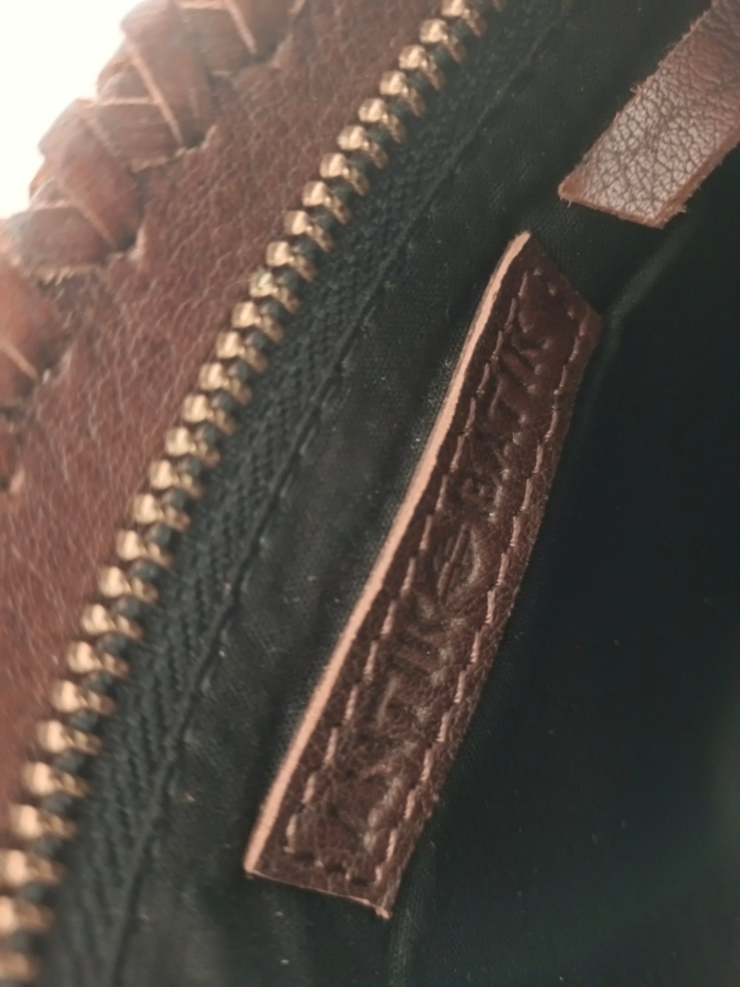 Bolso de mano de piel marrón y negro.