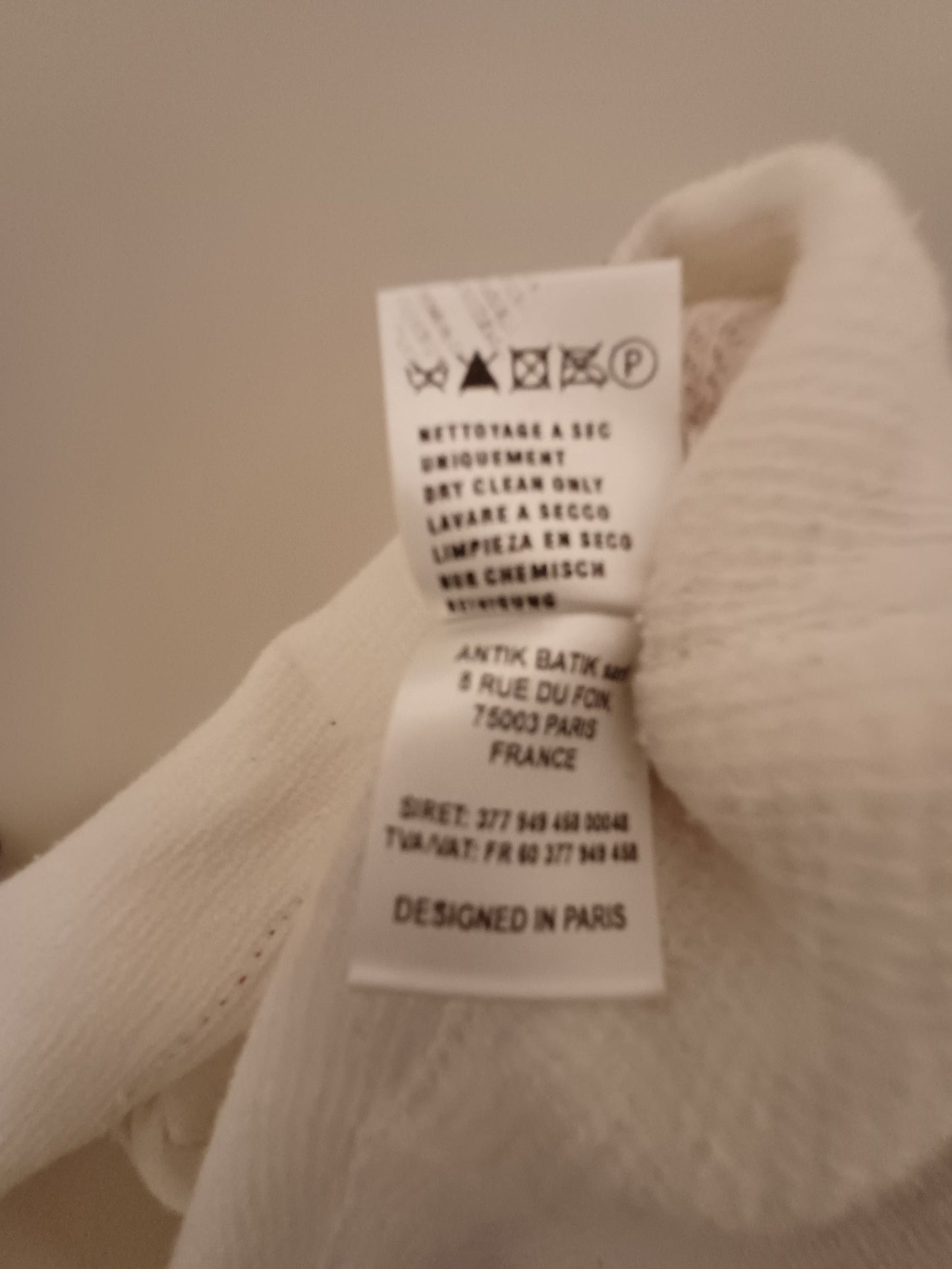 Cream-colored shirt with red embroidery